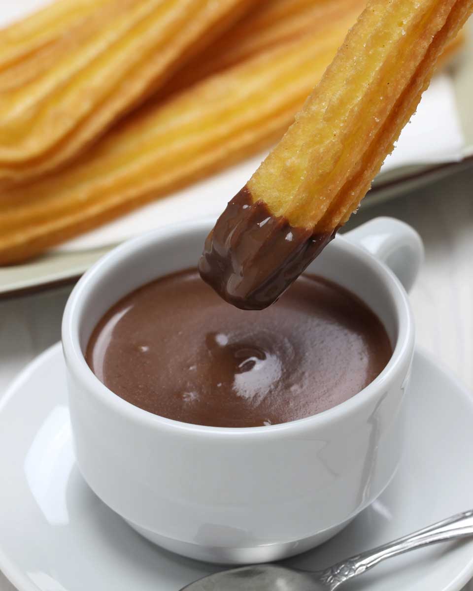 Churros dipped in chocolate in Madrid Spain