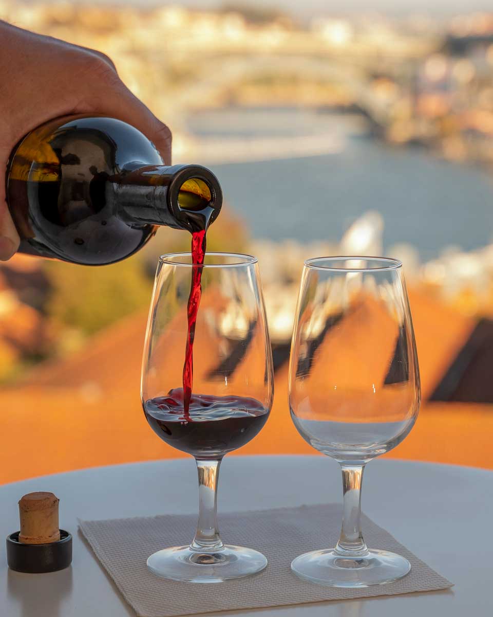 Port wine being poured at sunset in Vila Nova de Gaia Porto Portugal