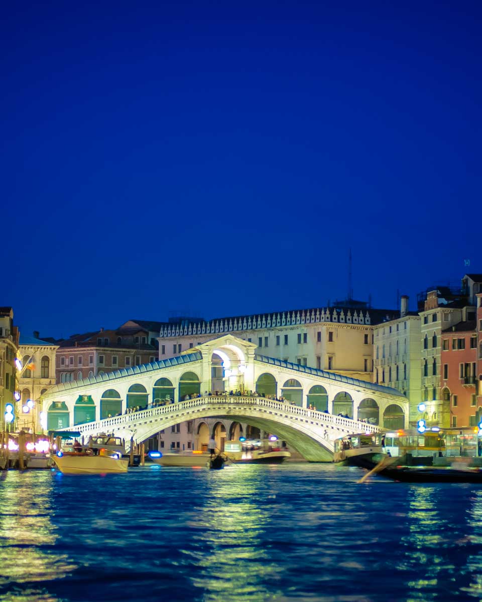 Rialto Bridge in Venice Italy during a night gondola ride on the canal