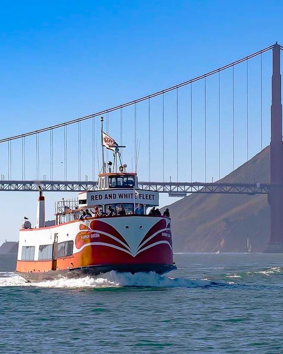 The Red and White Fleet boat cruises in front of the Golden Gate Bridge in San Francisco California