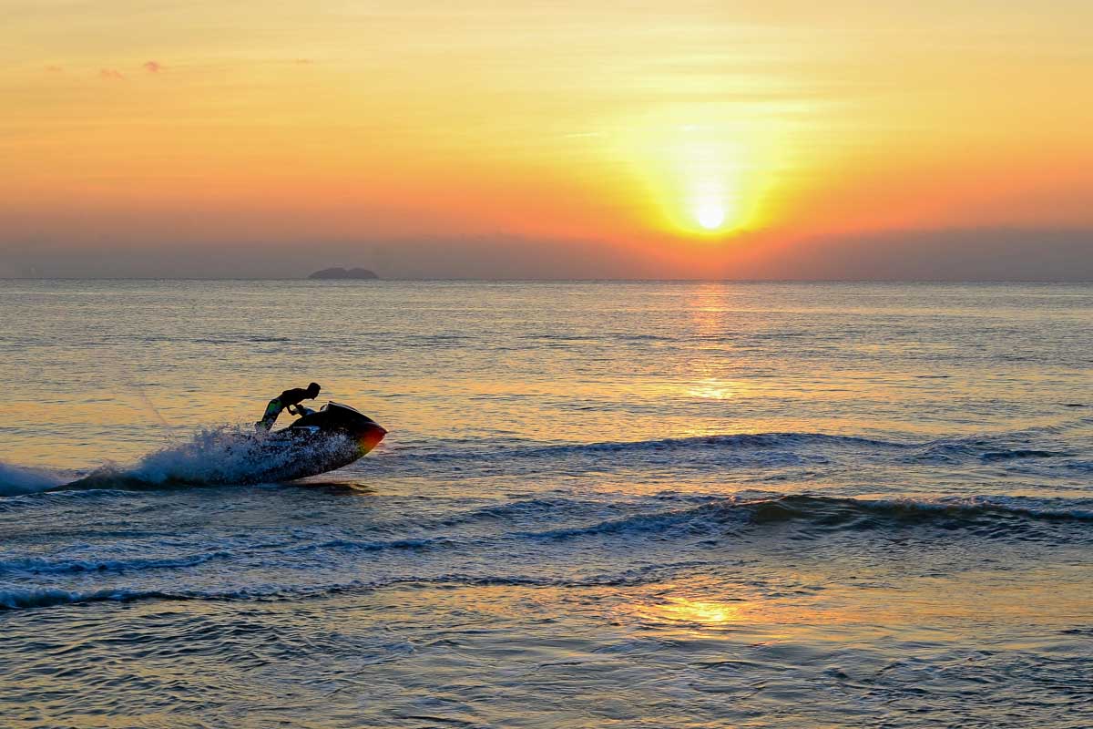 A-person-jet-skis-at-sunset-in-Darwin-Australia