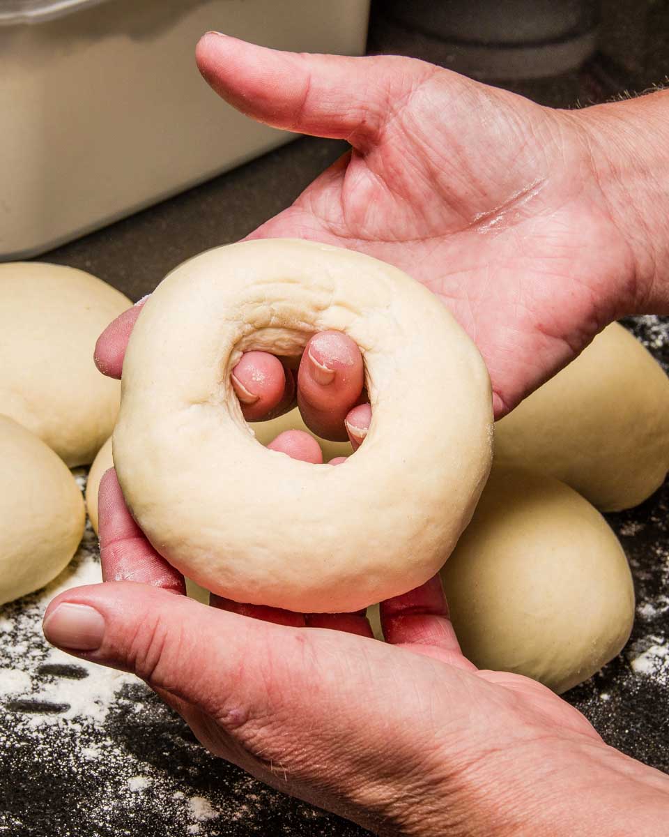 A person making a bagel in Montreal Quebec during a cooking class