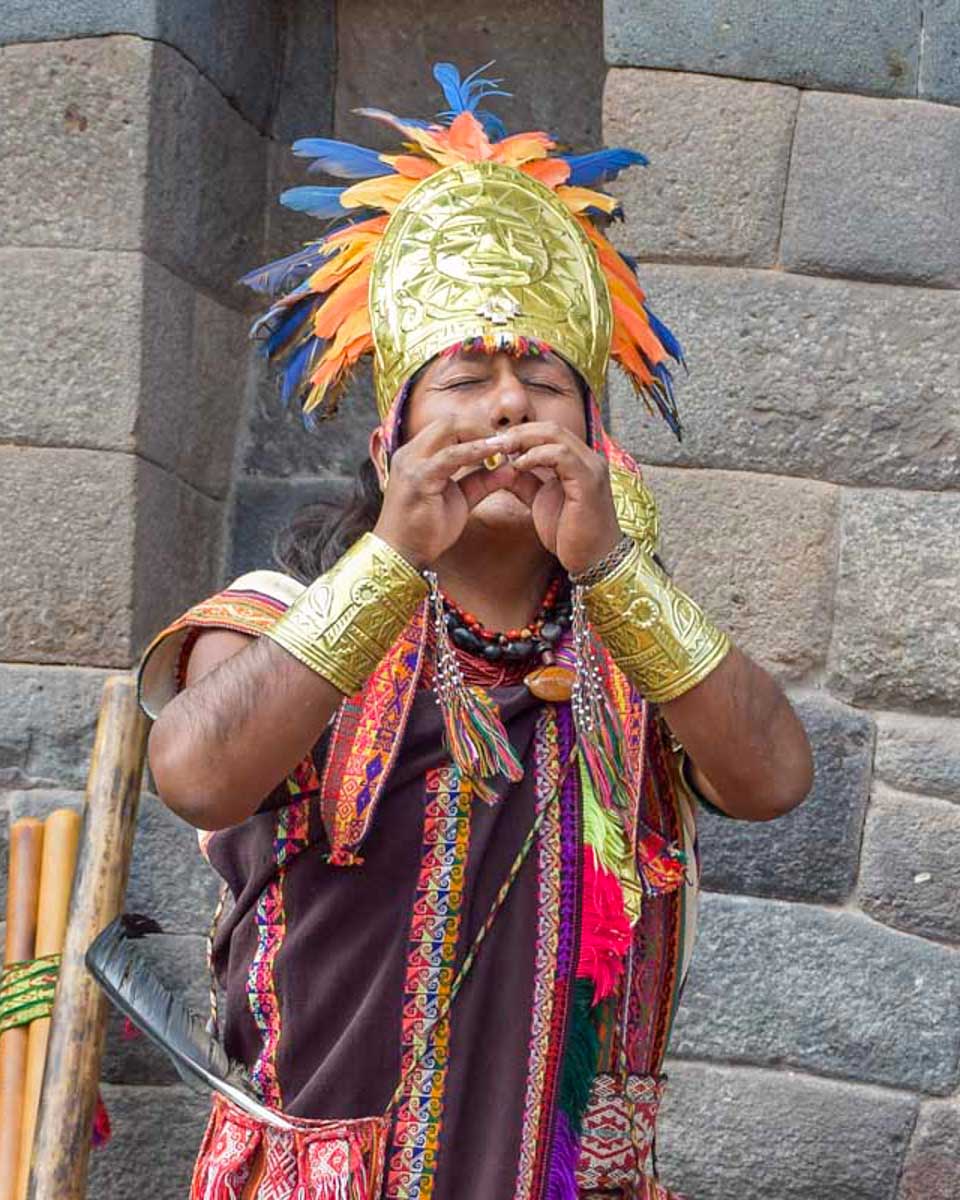 An Incan man plays music in the Historic Center of Cusco Peru