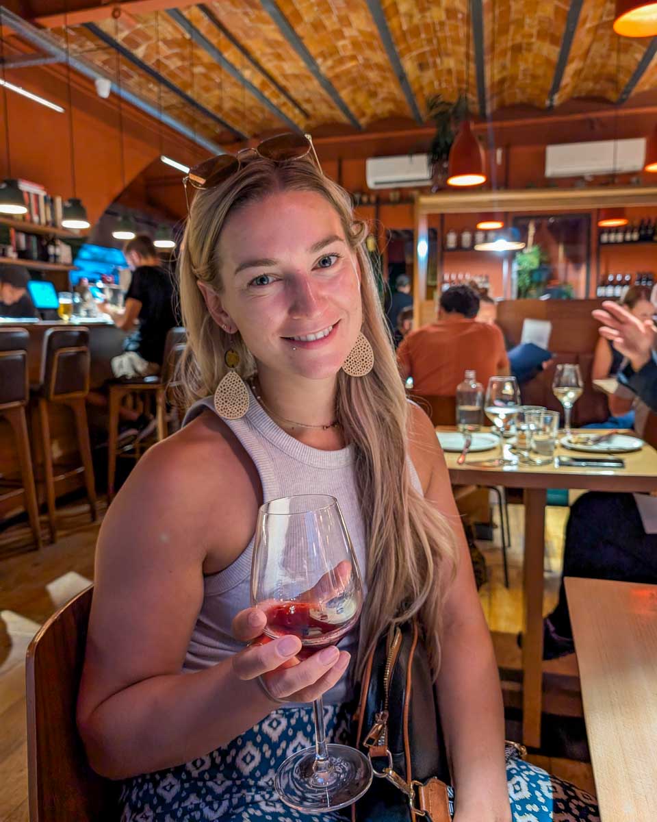 Bailey-drinks wine in Santorini Greece