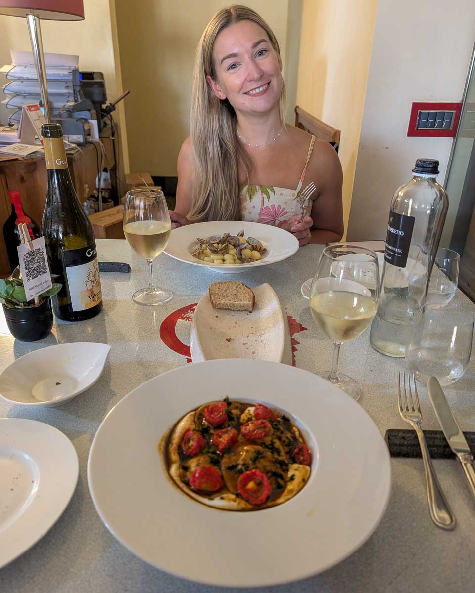 Bailey eats dinner iwith wine in Valencia Spain