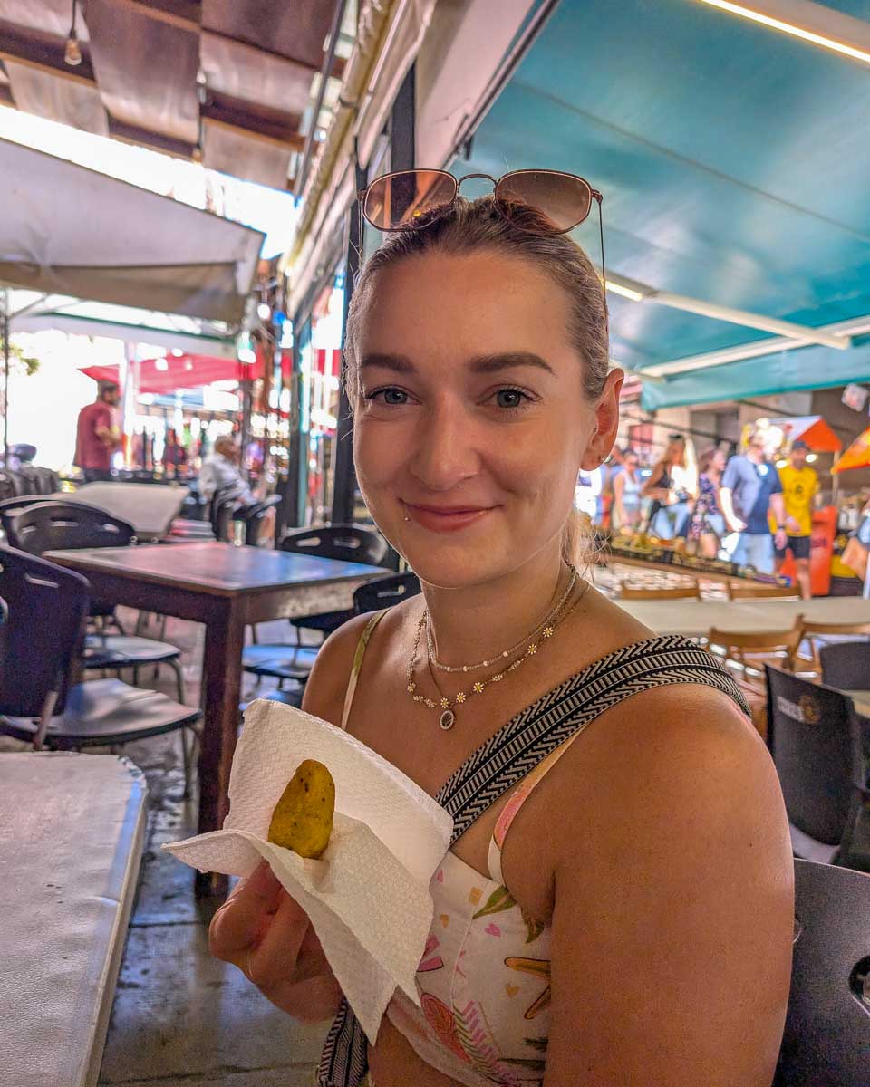 Bailey-holds-food-on-a-food-tour-in-Porto Portugal