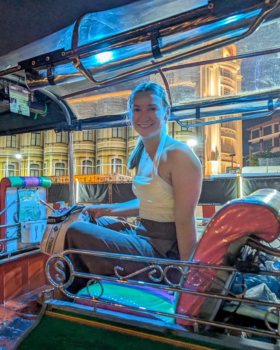 Bailey sits in a tuk tuk at night on a tour in Bangkok Thailand