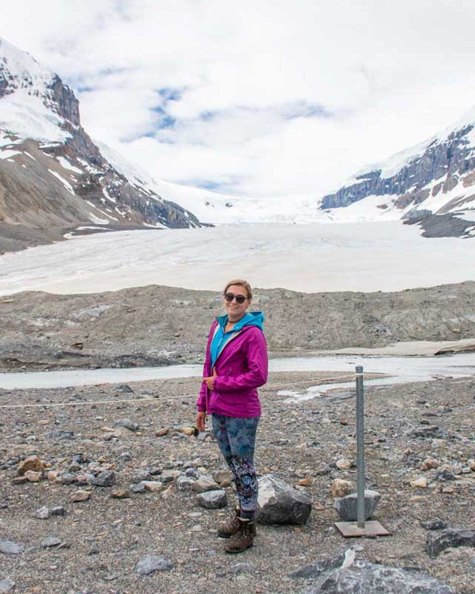 Bailey-stands-at-the-Toe-of-the-Athabasca-Glacier-in-Canada on a tour of the icefields parkway