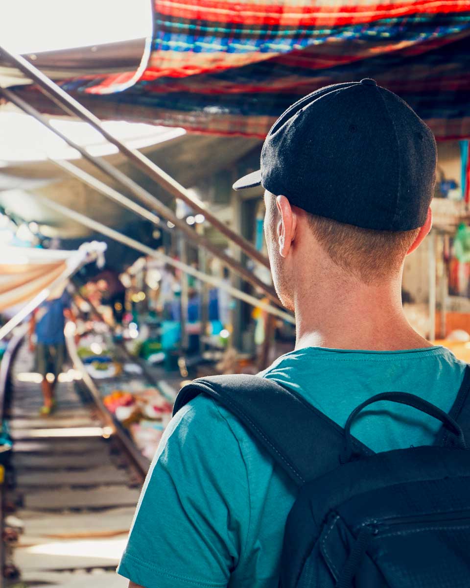 Daniel at maeklong railway market on a tour in Bangkok Thailand