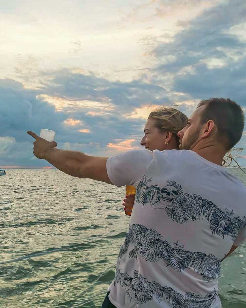 Daniel-points-to-something-while on a sunset cruise of Cinque Terre from Monterosso Italy