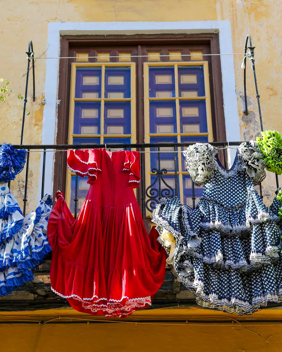 Dresses hang in a window in Seville Spain
