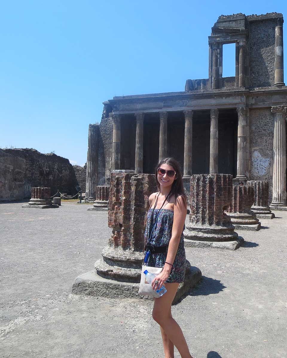 My-sister-poses-in-front-of-the-Pompeii-ruins-on-a-day-trip-from-Positano Amalfi Coast Italy