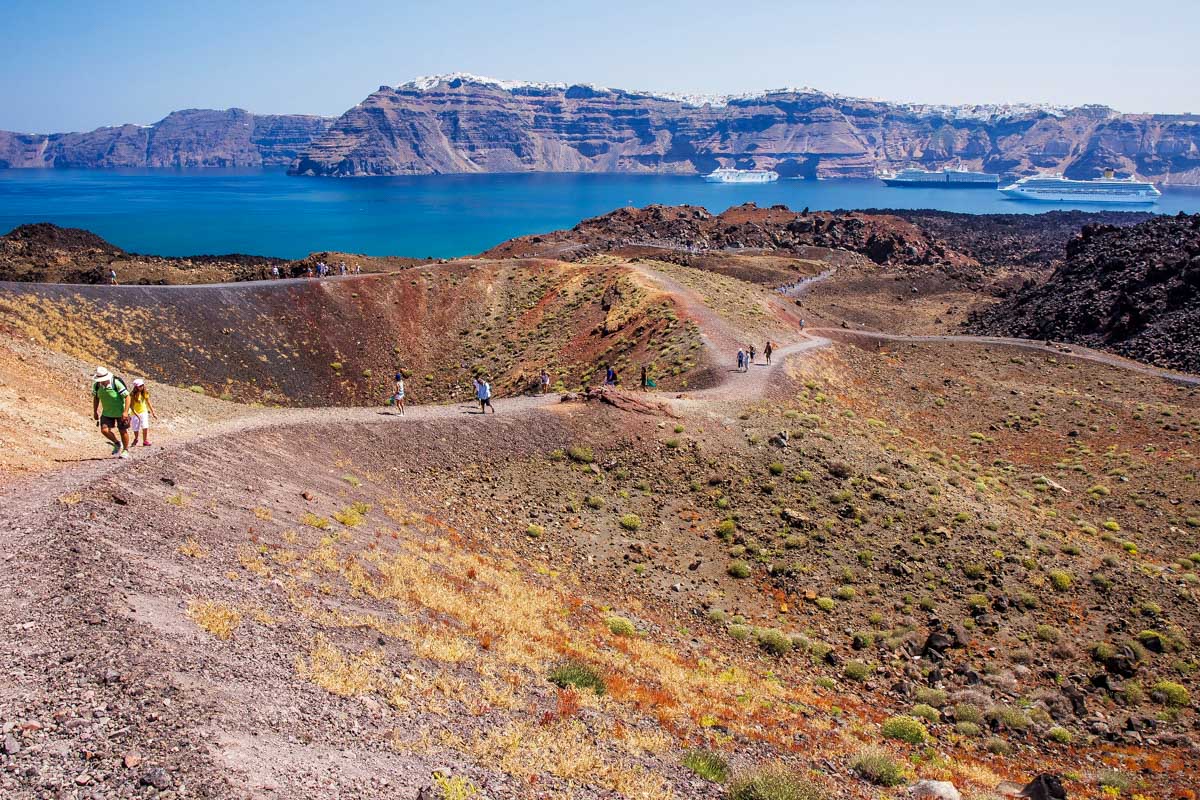 People hike on the Fira to Oia Hike in Santorini Greece