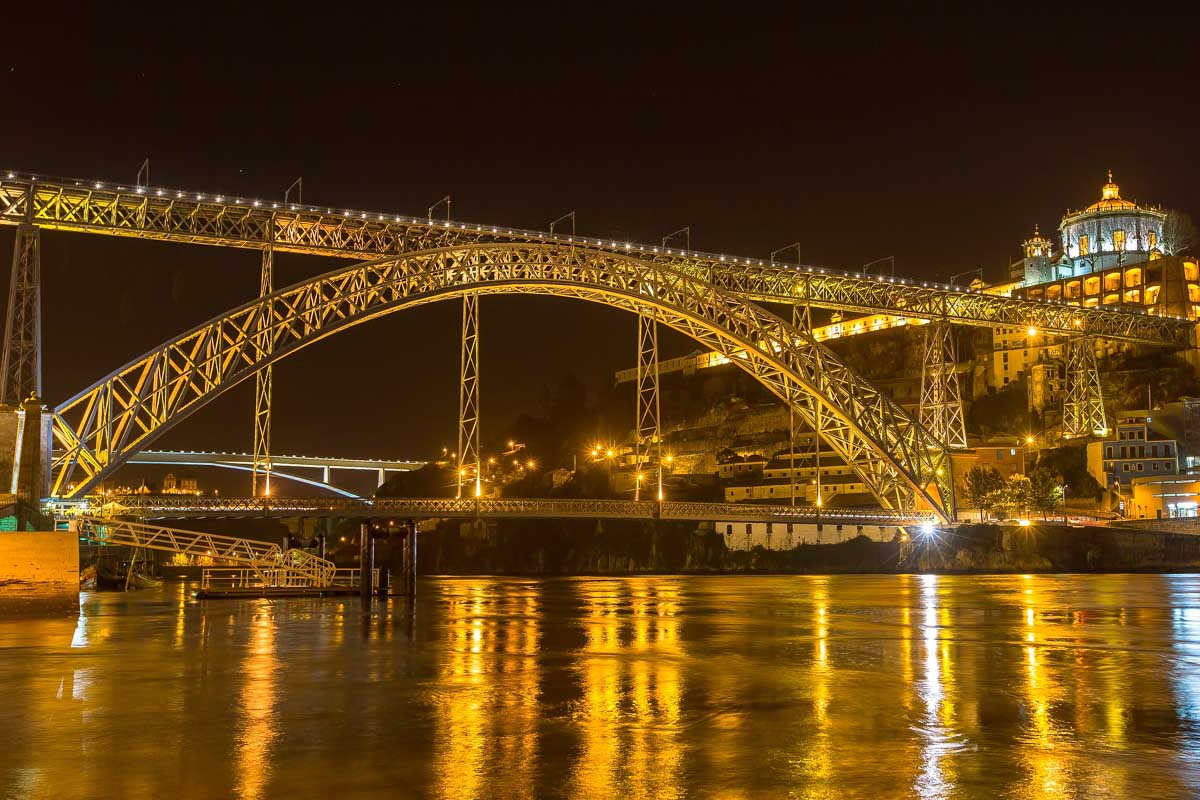 The Dom Luís I Bridge on the Cais da Ribeira at night in Porto Portugal