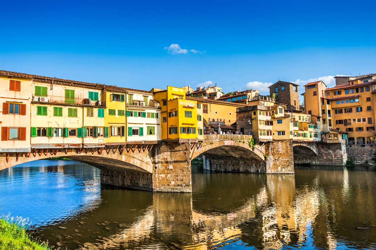 The Ponte Vecchio with river Arno at sunset in Florence