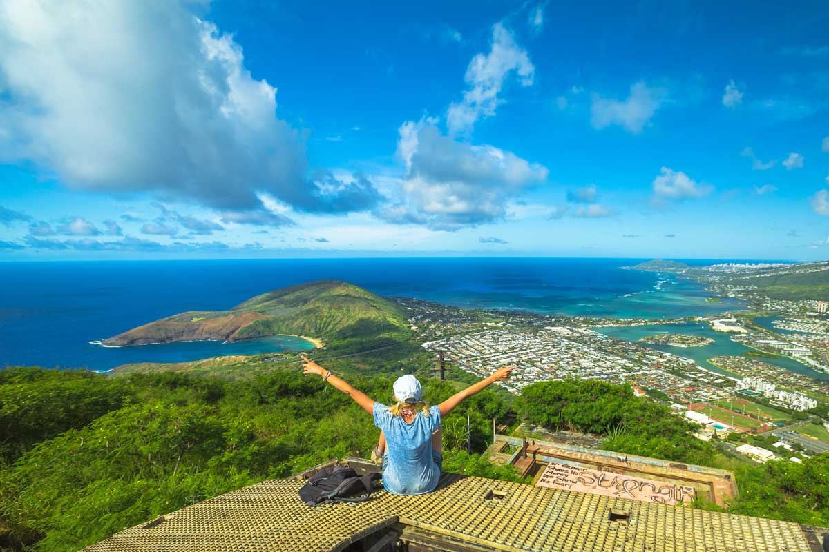 A woman enjoys the panoramic view from a Diamond Head lookout