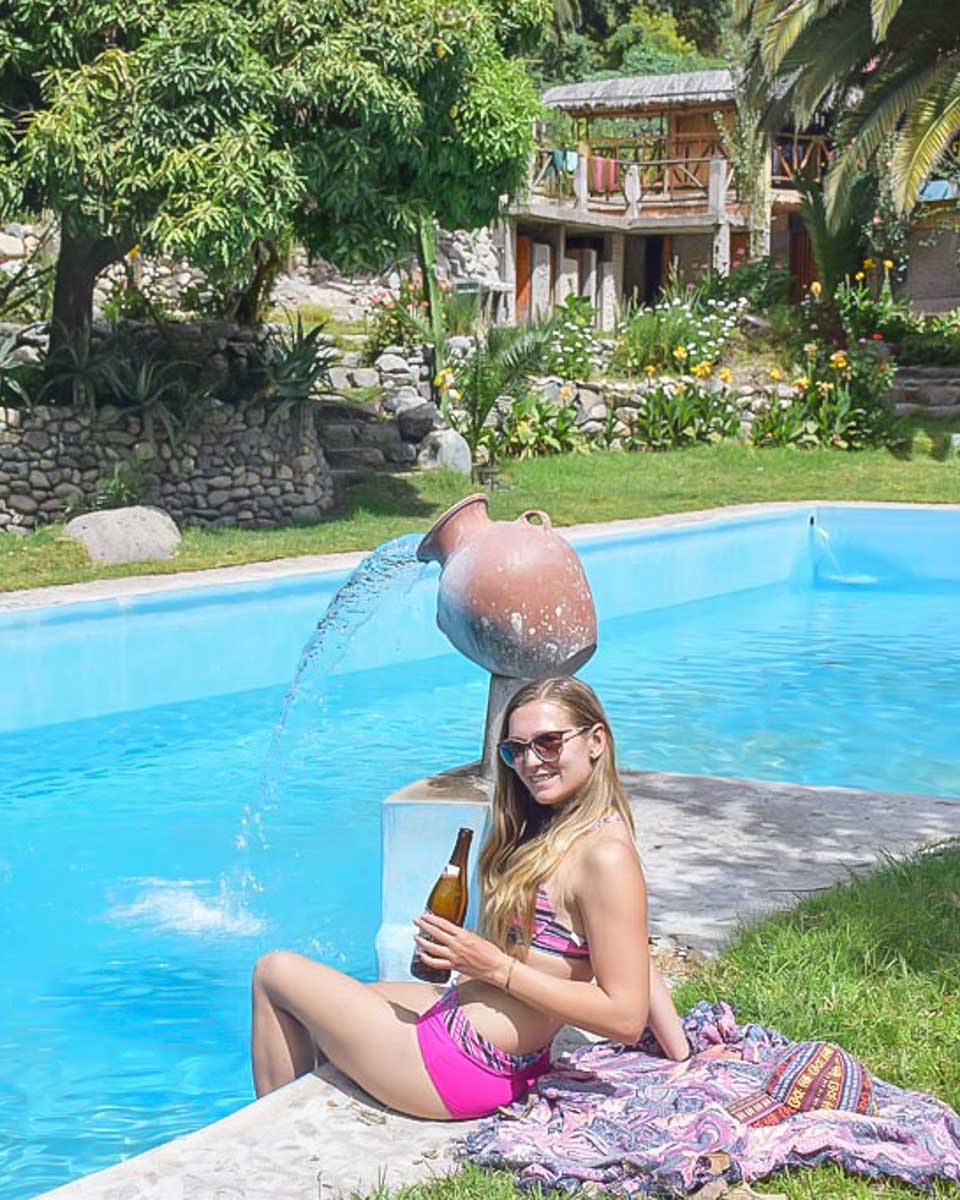 Bailey relaxes by the pool with a beer after hiking in the Colca Canyon
