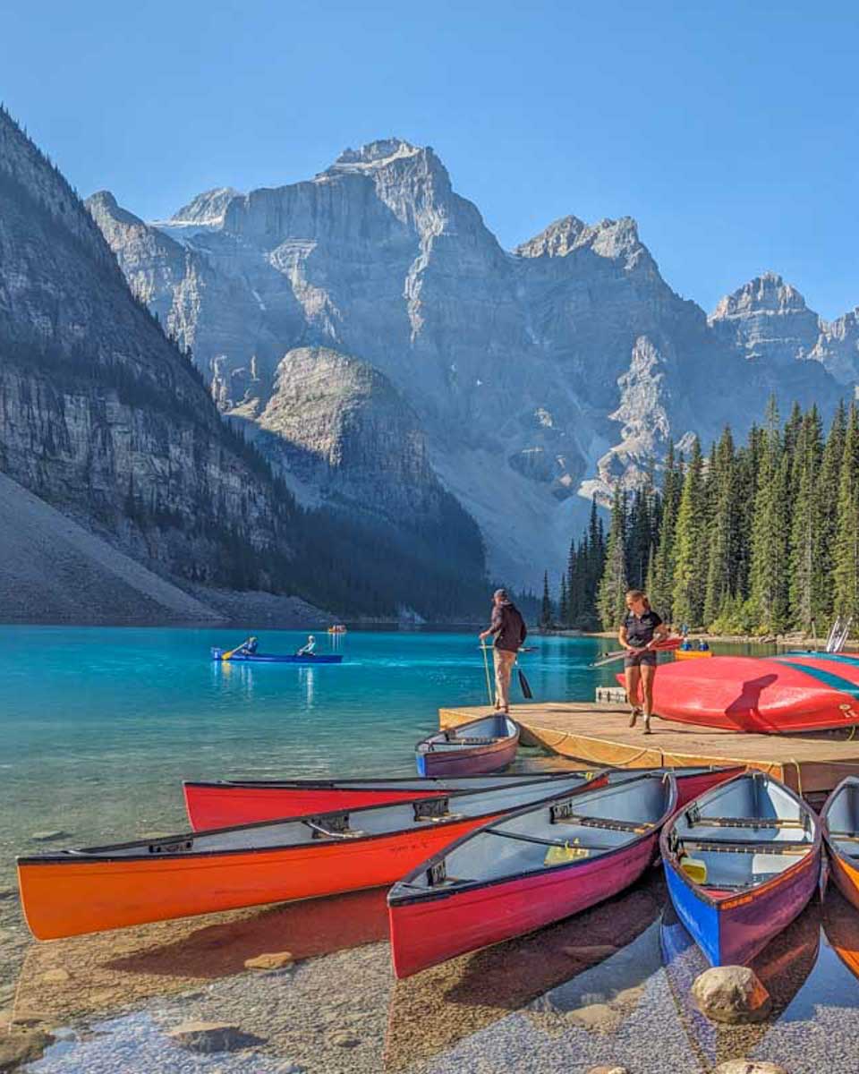 Canoes-sit-in-the-water-at-Moraine-Lake-Banff-National-Park on a tour from Calgary Alberta