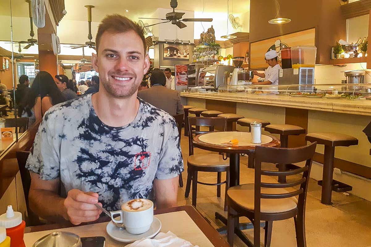 Daniel has coffee and churros at Manalo in Lima Peru