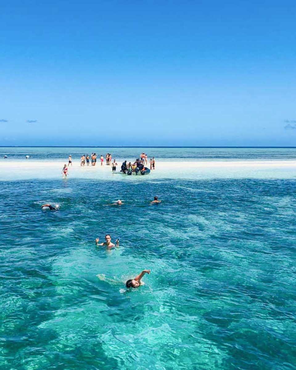 People-swim-around-a-sandbar-on-the-Cruisin-Fiji-Authentic-Fijian-Day-Cruise