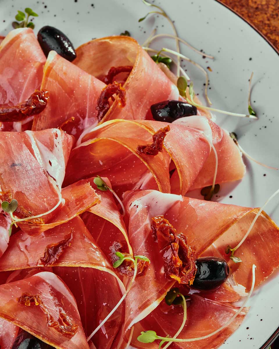 A-meat-plate-with-olives-eaten-on-a-wine tour in San Sebastian Spain