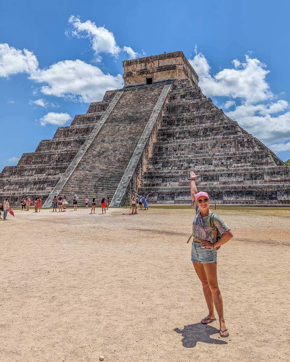 Bailey-poses-for-a-photo-in-front-of-El-Castillo-Pyramid-at-Chichen-Itza-Mexico on a tour from Tulum