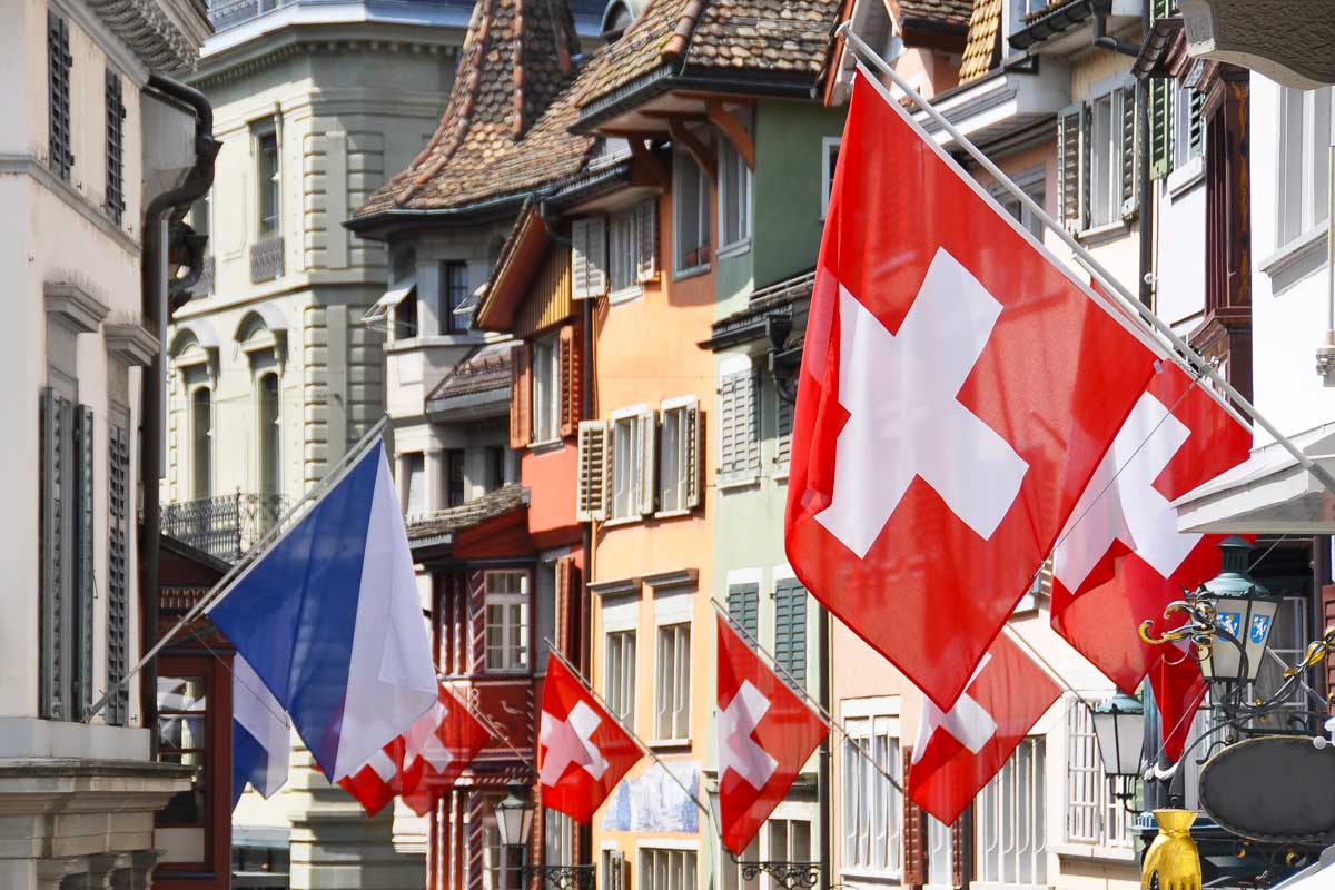 Old street in Zurich decorated with Swiss flags