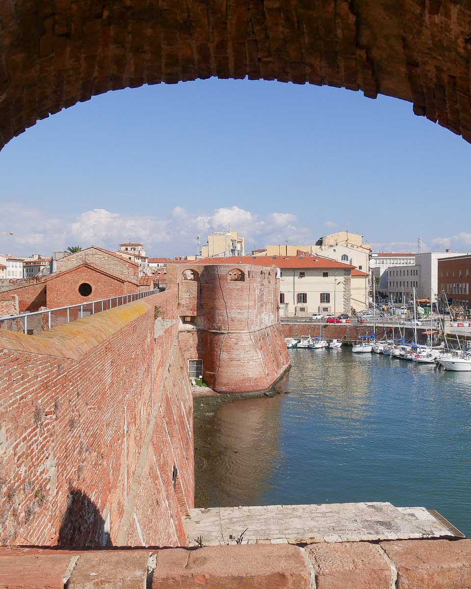 Panorama through an arch of the walls of Fortezza Vecchia fortress in Livorno Italy