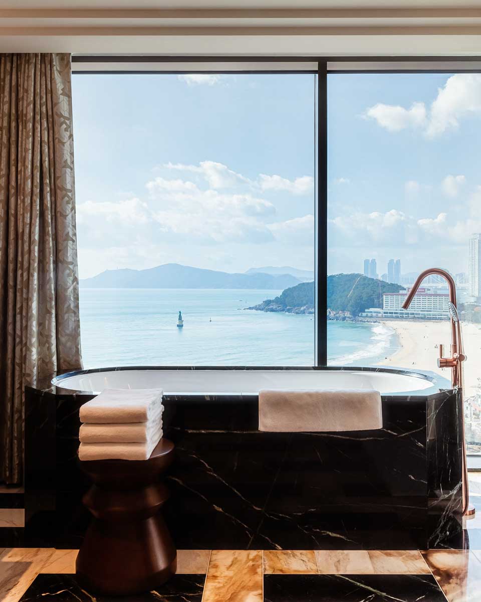 A soaking bathrub with a view of the ocean at the Grand Josun Busan