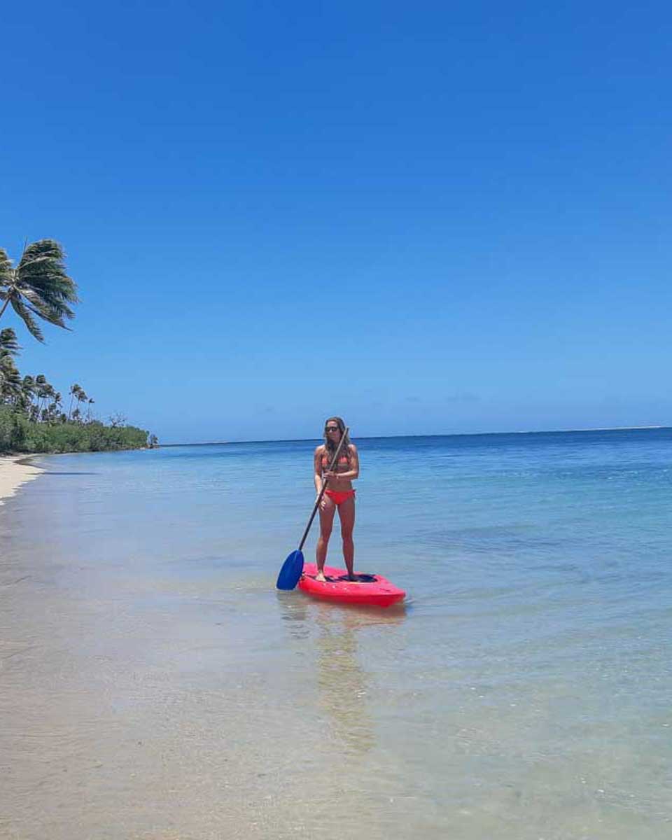 Bailey-on-a-stand-up-paddle-board-out-in-the-water-of-Palm Beach Aruba