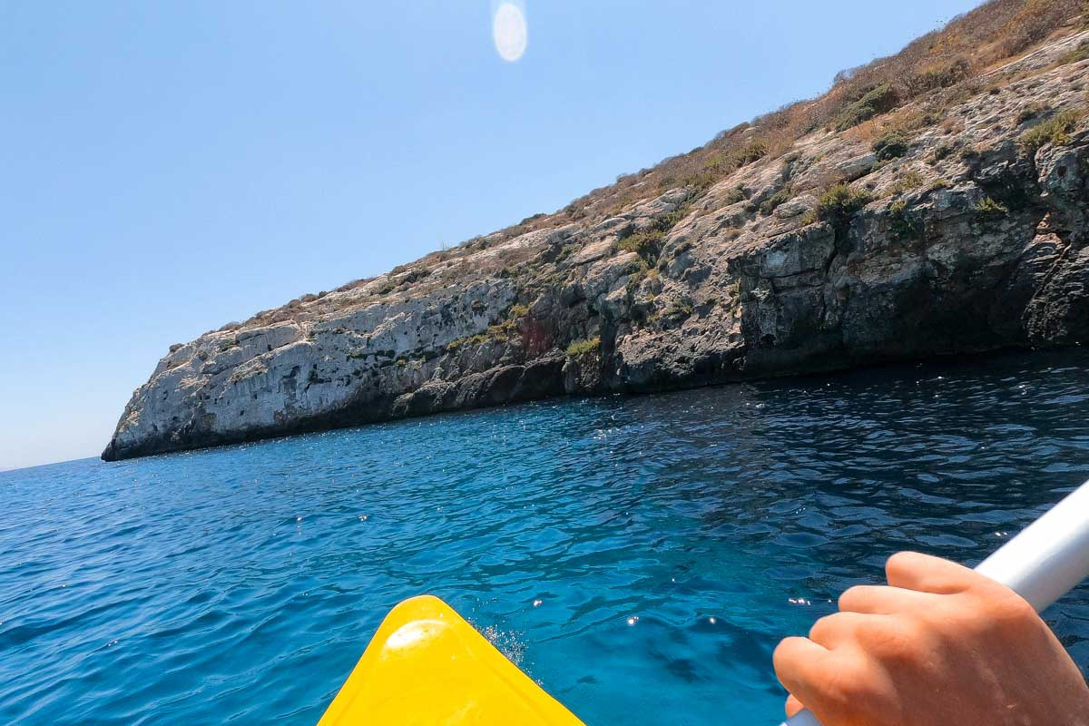 Daniel kayaks off of the coast of Sardinia Italy on a tour