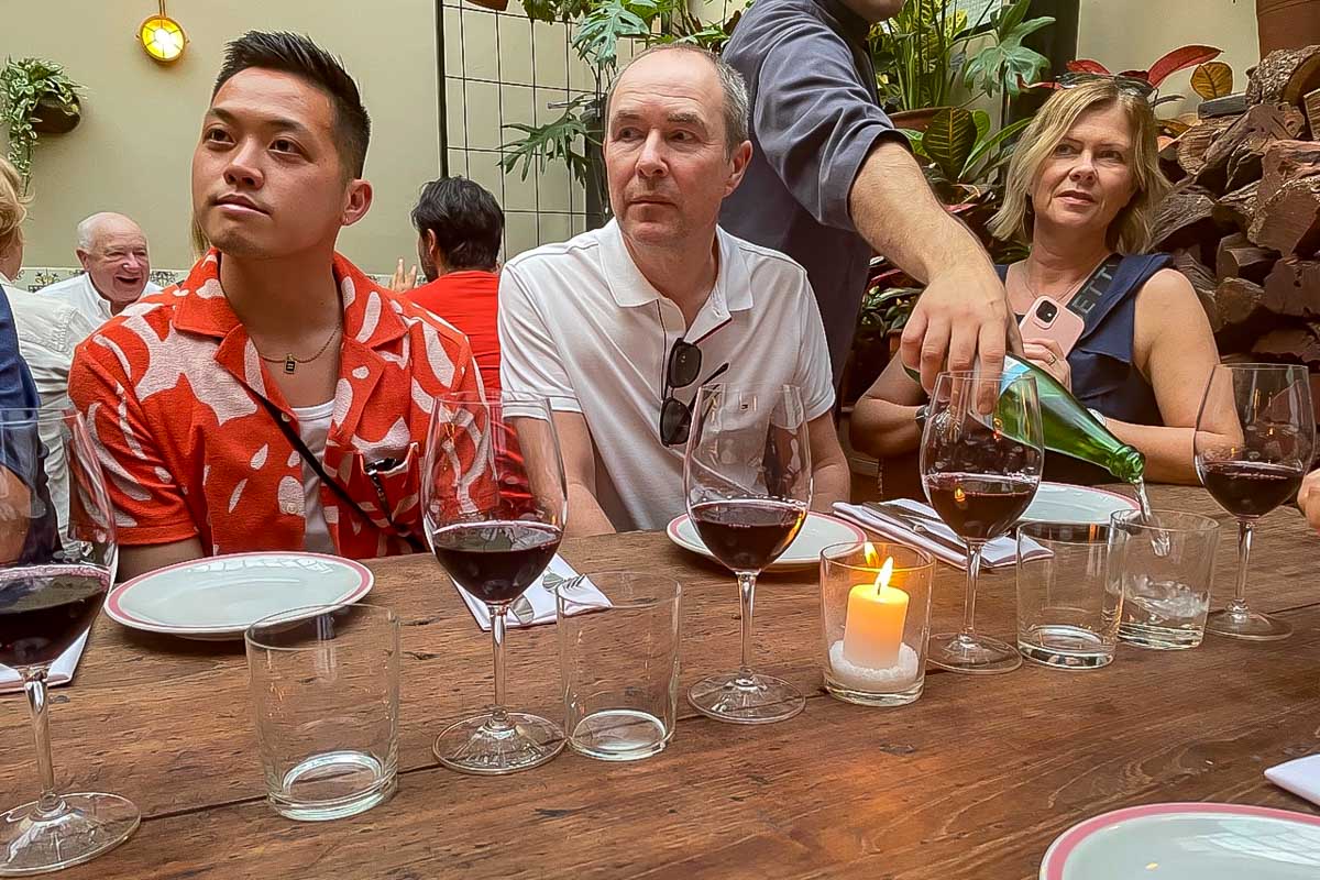 People-listen-to-their-guide-and-drink-wine-on-a-sherpa-food-tour-in-Naxos Greece