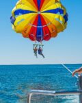 Two-people-parasail-over-the-ocean-in Turks and Caicos