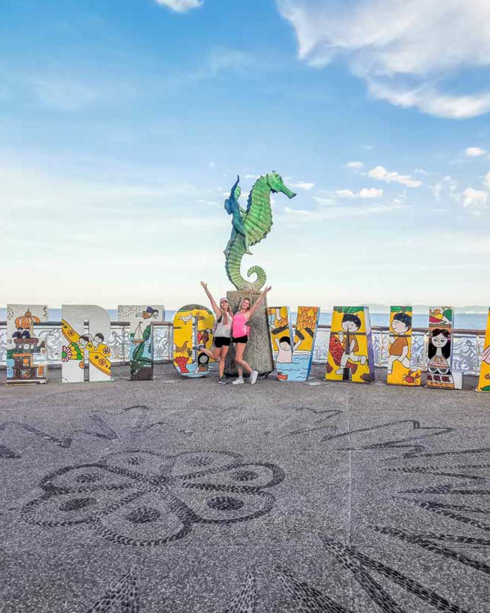 Two-people-pose-for-a-photo-on-the-Puerto-Vallarta-Malecon Mexico