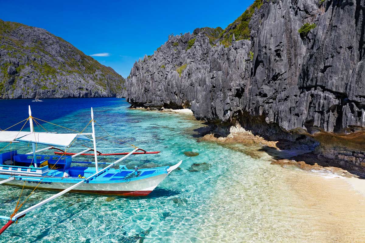 A beach and boat seen in El Nido Philippines