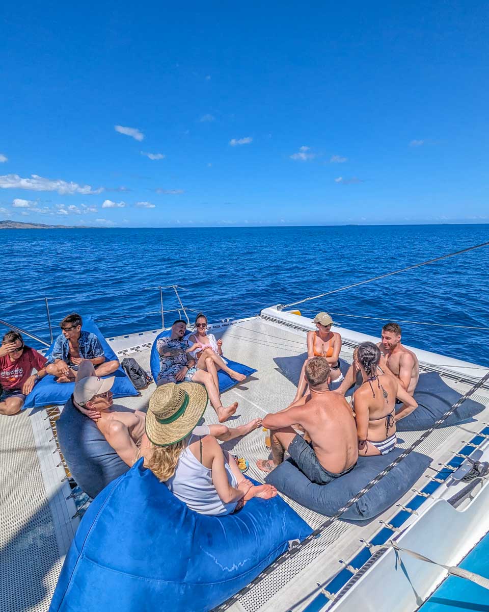 A-group-of-people-relax-on-the-seating-on-a-catamaran-in-El Nido Philippines