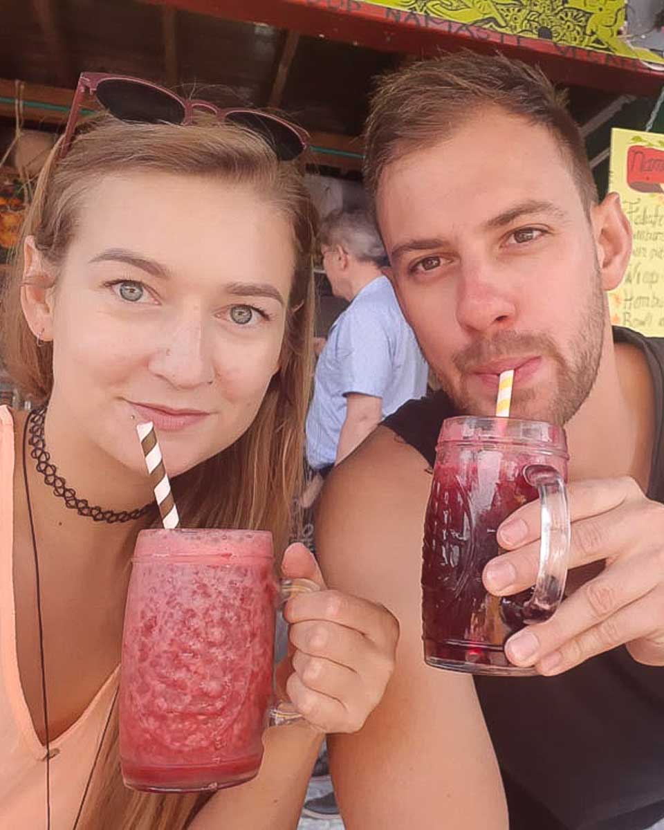 Bailey and Daniel drink fresh juice on a food tour of Bogota Colombia