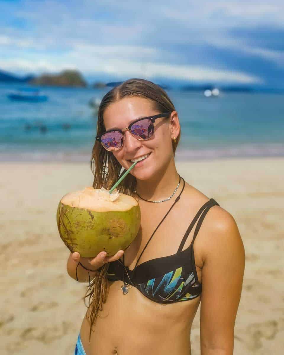 Bailey-sips-a-coconut-in-El Nido Philippines