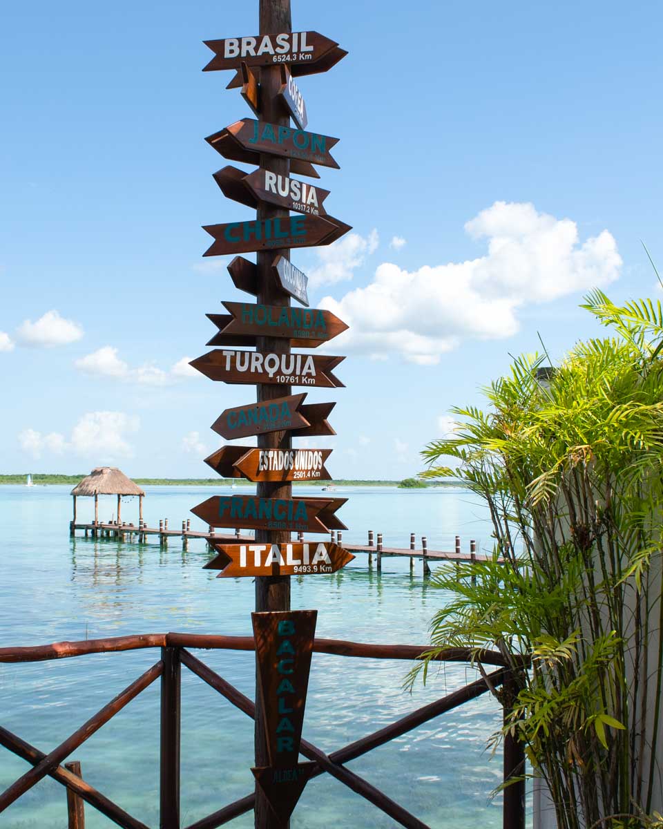 A sign in front of the lagoon at Hotel Aldea19 Bacalar