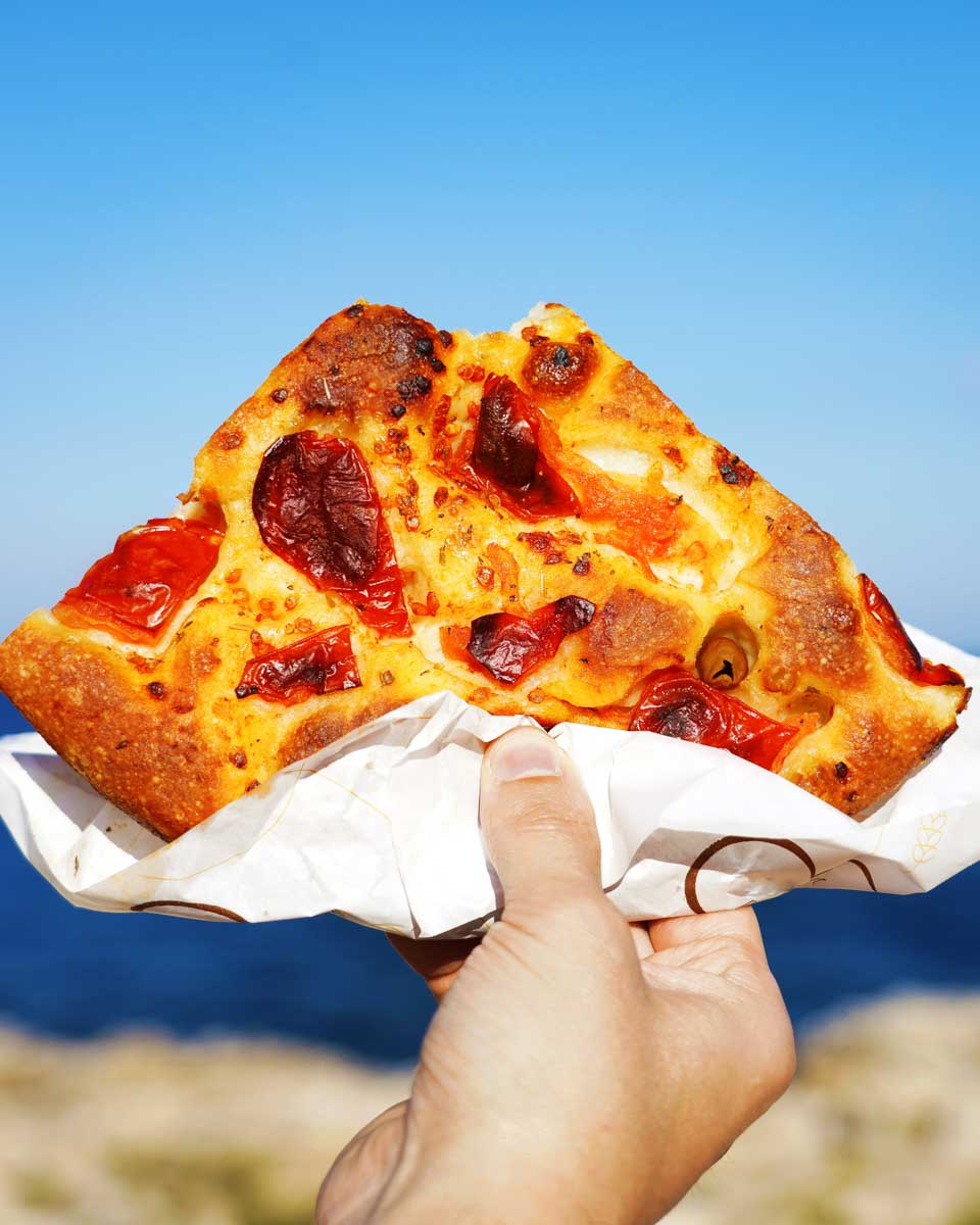 A-slice-of-pizza-eaten-on-a-bike-tour-of-Bari-Italy on a tour from Puglia
