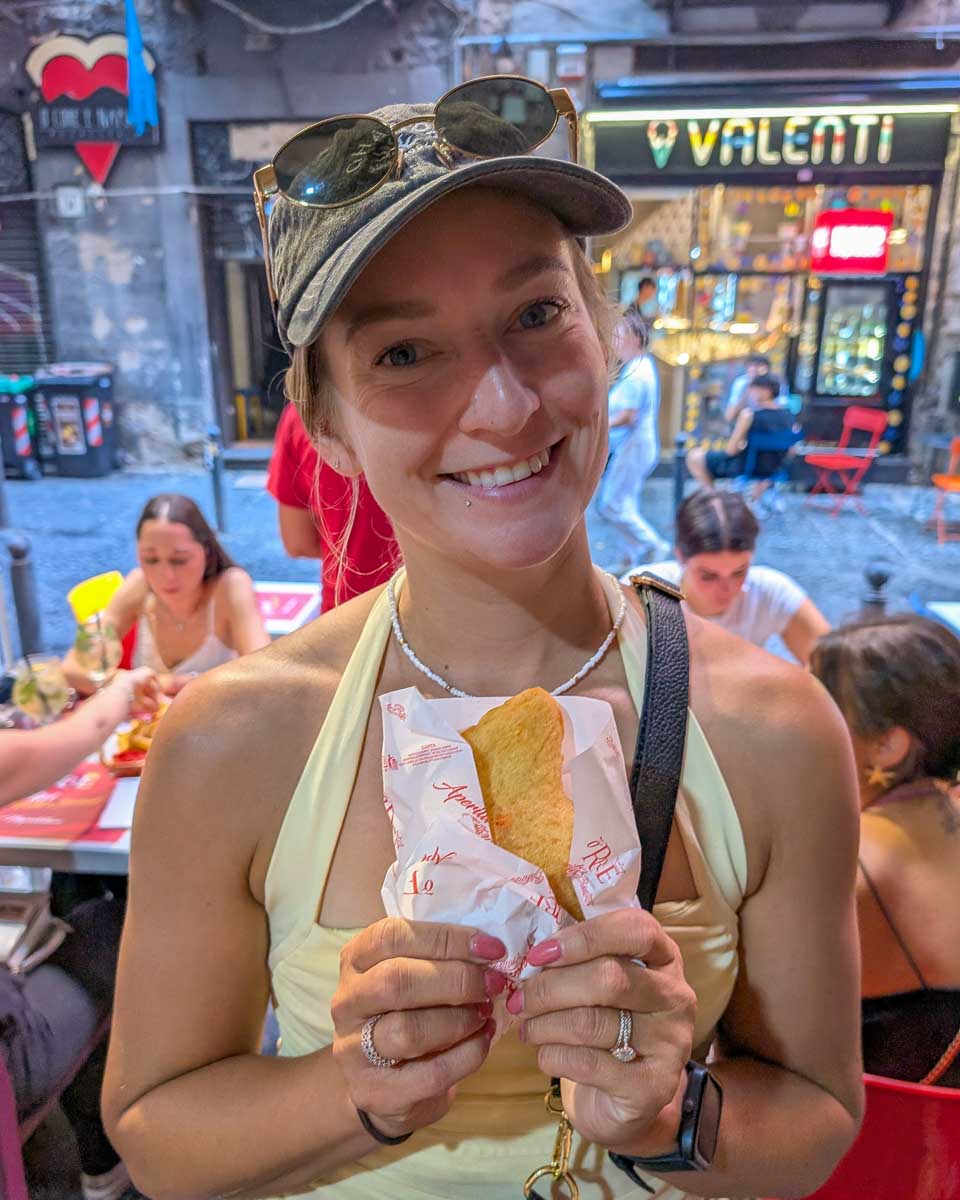 Bailey eats pizza fritta on a food tour of Naples Italy