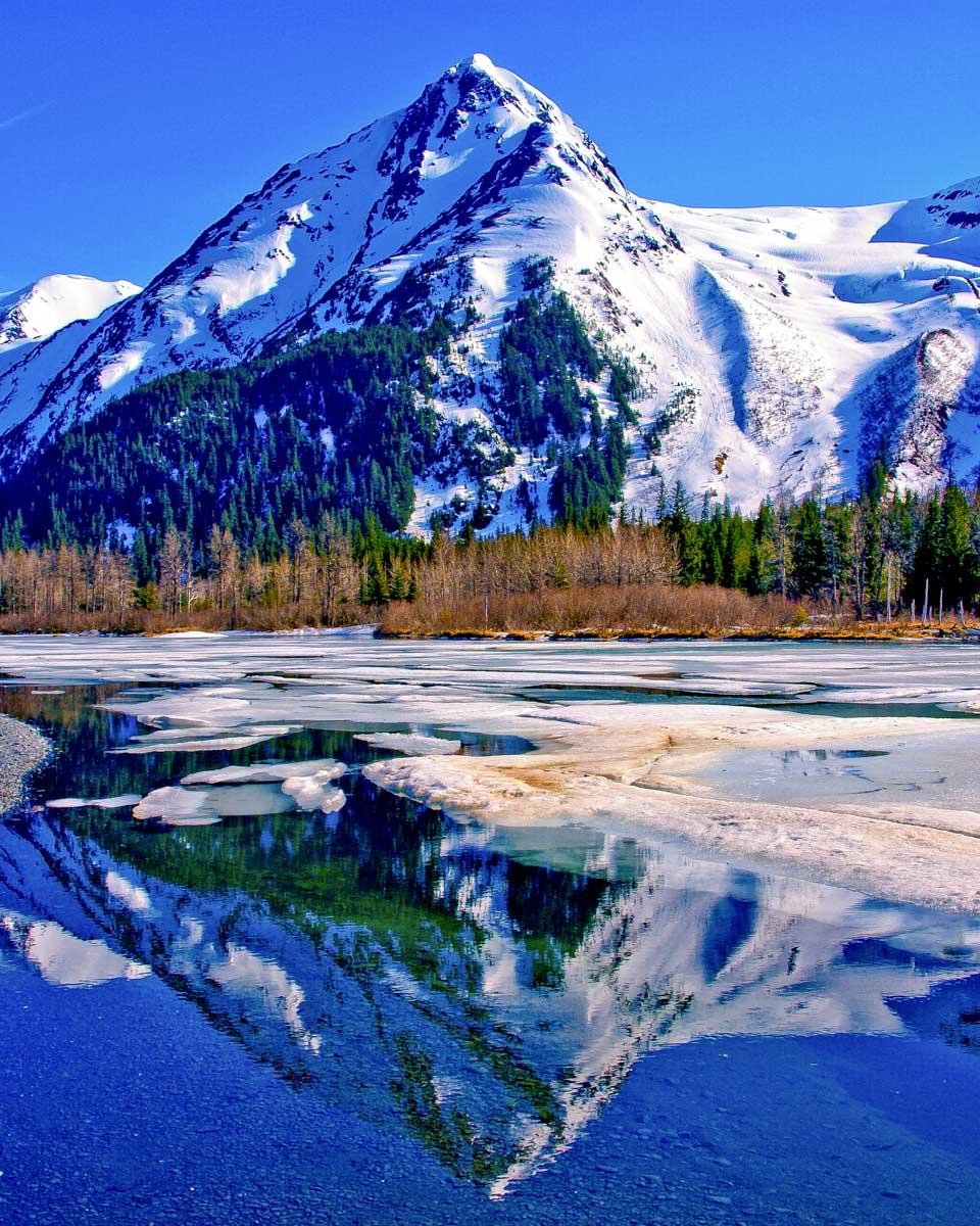 View of a partially frozen lake and mountain seen in Anchorage Alaska