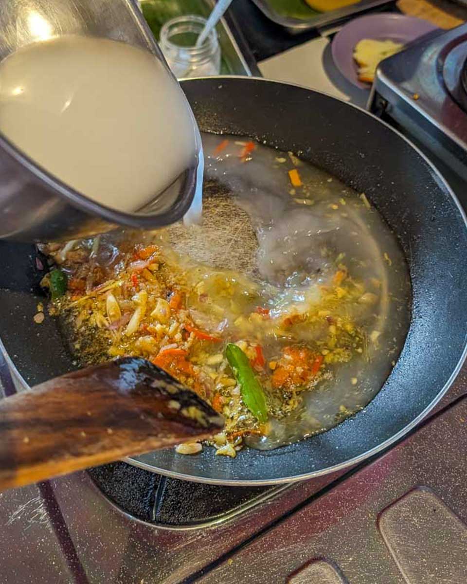 A-person-cooks-with-a-pan-during-a-cooking-class-in-Nassau Bahamas