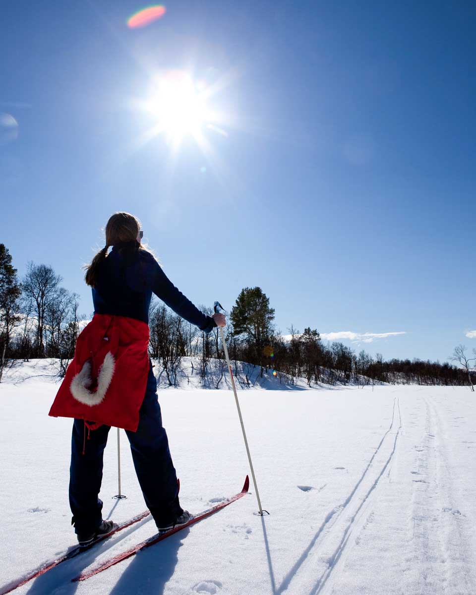 A-woman-cross-country-skis-in- Rovaniemi, Finland