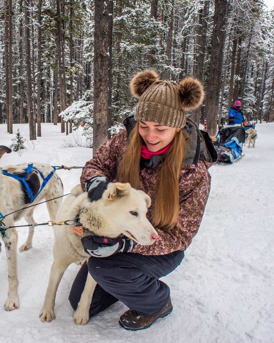 Bailey-with-one-of-the-dogs-on-our-dog-sledding-tour-in-Rovaniemi, Finland