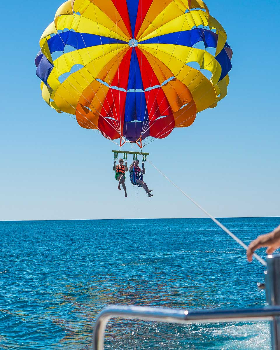 Two-people-parasail-over-the-ocean-near-Gold Coast Australia