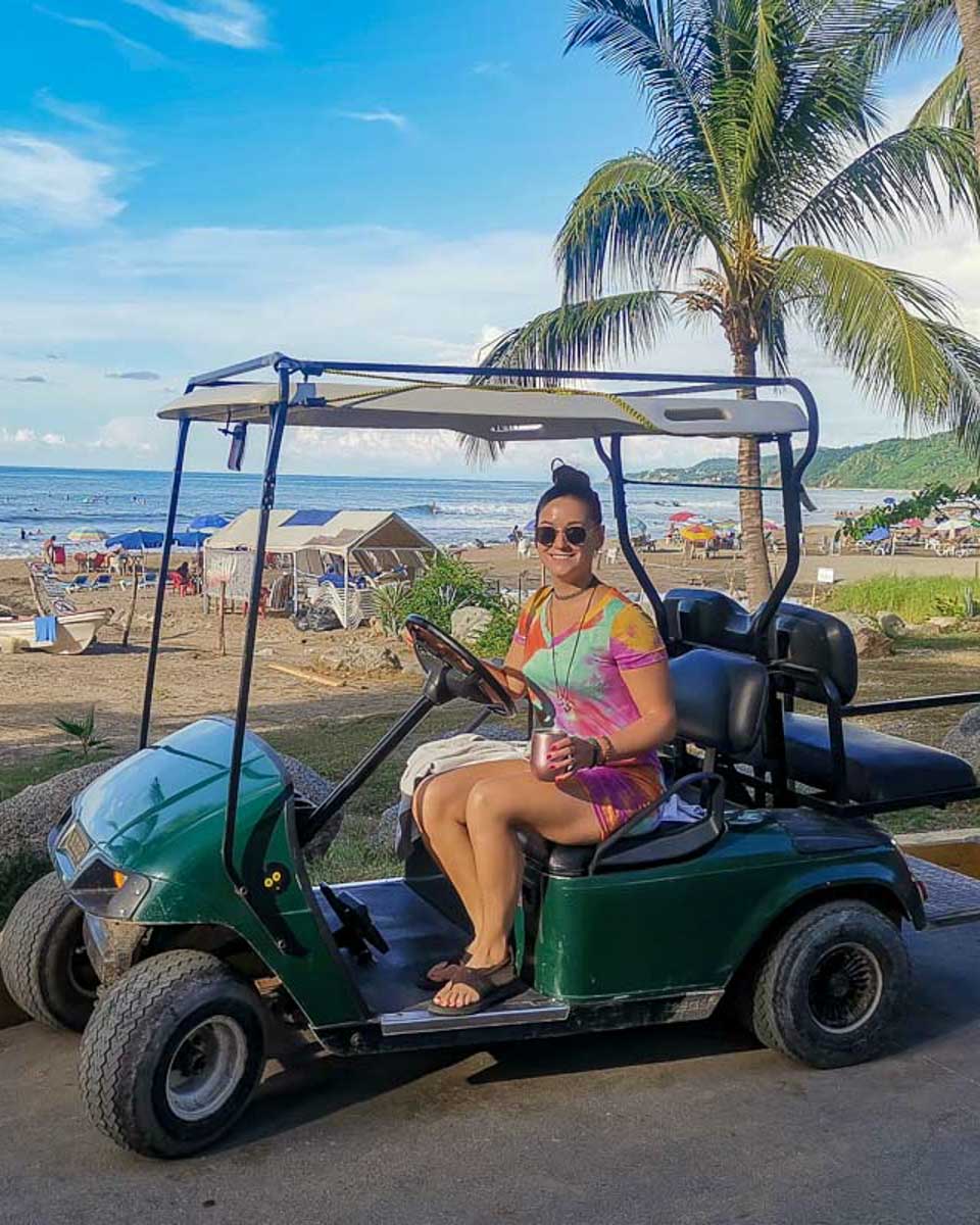 Bailey drives a golf cart in Sayulita Mexico