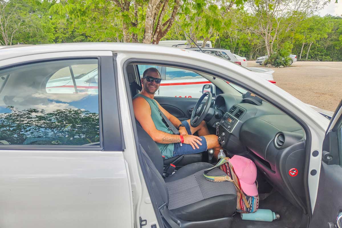 Bailey-takes-a-photo-of-Daniel-while-he-sits-in-our-Belize-Rental-car