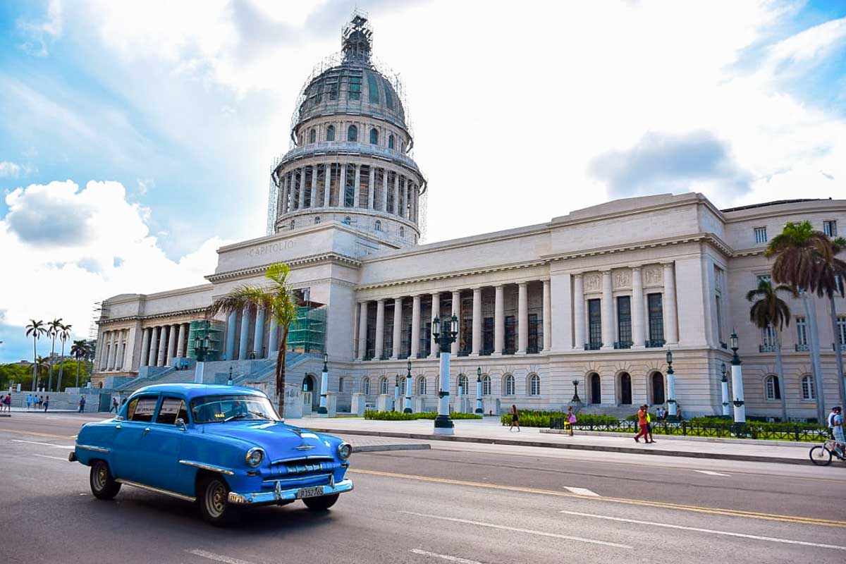 A classic car drives in havana cuba